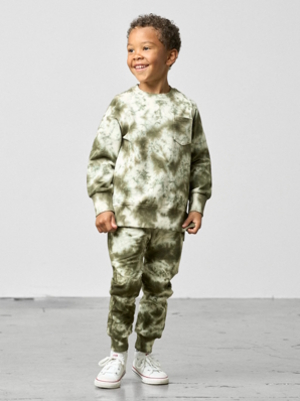 boy wearing tie-dyed pants and sweatshirt