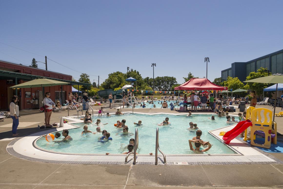 View of swimmers at Seattle Pop Mounger outdoor pool in Magnolia neighborhood open seasonally summer