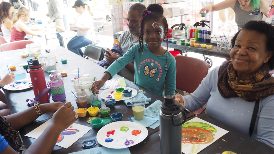 families painting in the makers space at NW Folklife
