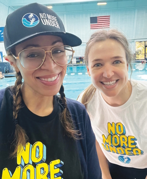 two people smiling wearing No More Under shirts