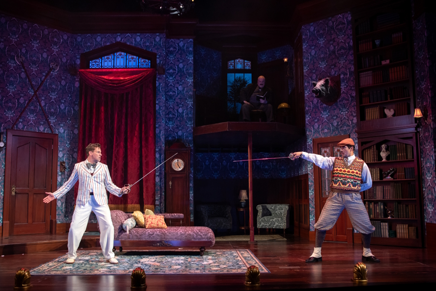 Cast members from the play in a sword fight on stage