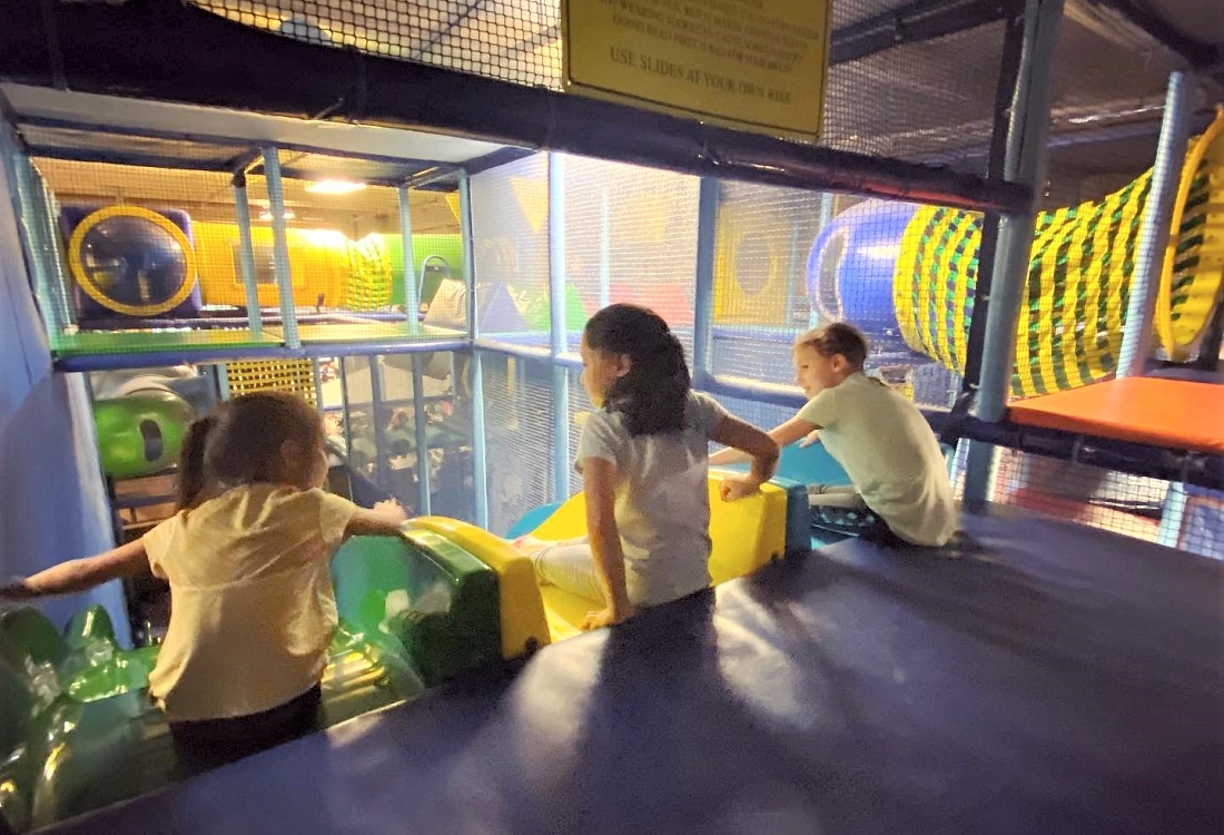 Kids at the top of the slides at Playdate SEA a Seattle indoor play spaces for kids and families rainy day play