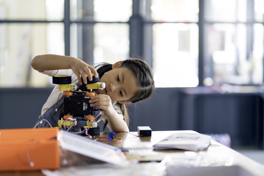 Young girl workong on a STEM project at her local library