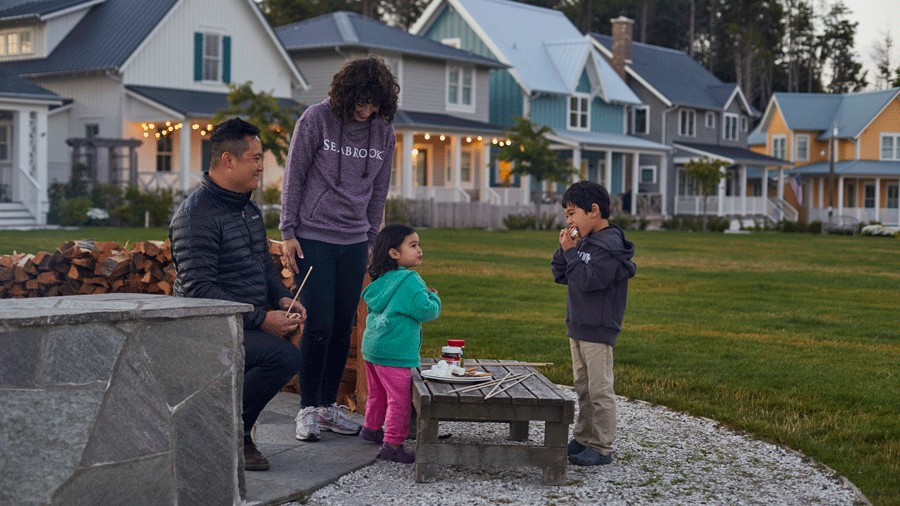 family roasting s'mores outside their seabrook rental during the off-season