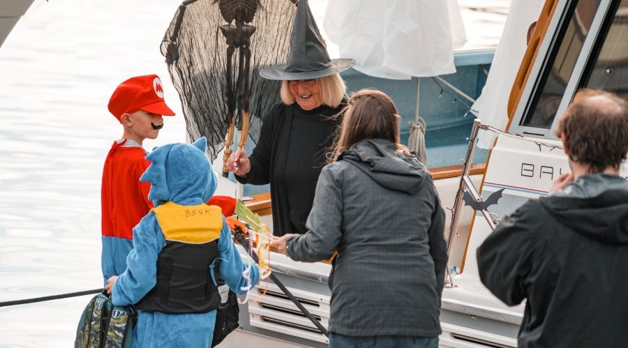 Costume kids trick or treat at boats docked at the Port of Everett .