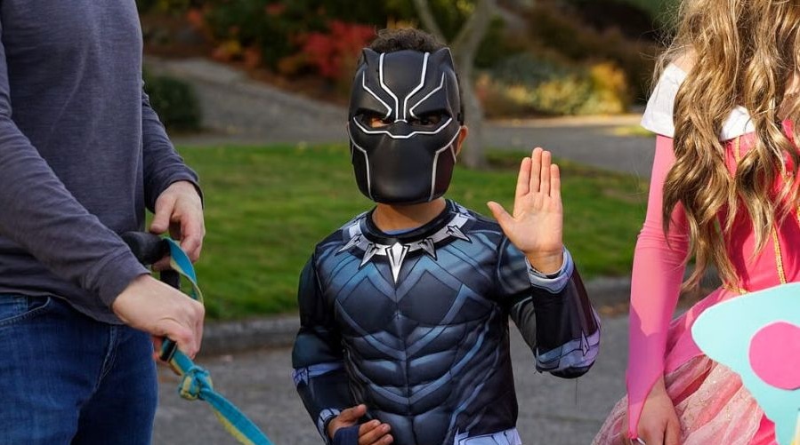 Boy dressed as Black Panther walks the Halloween parade at T’Challaween.