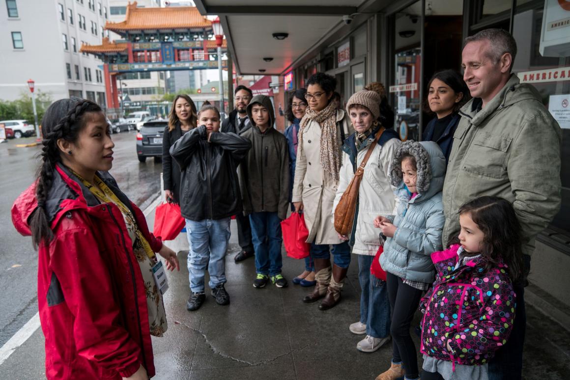 walking tour group in the rain in seattle's chinatown international district