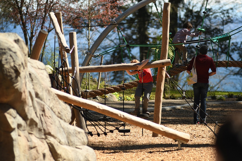 Wide view of kid playing on Suquamish Shores Natural Play Area