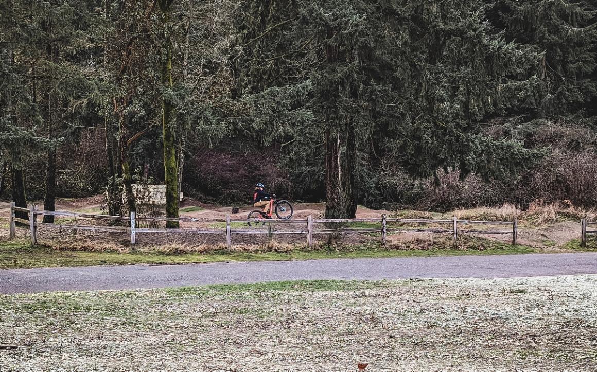 View of mountain biker on Swan Creek Park pump track