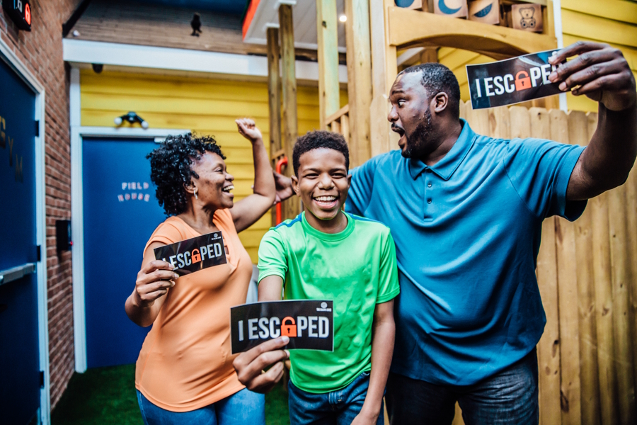 family holding up "I escaped" signs