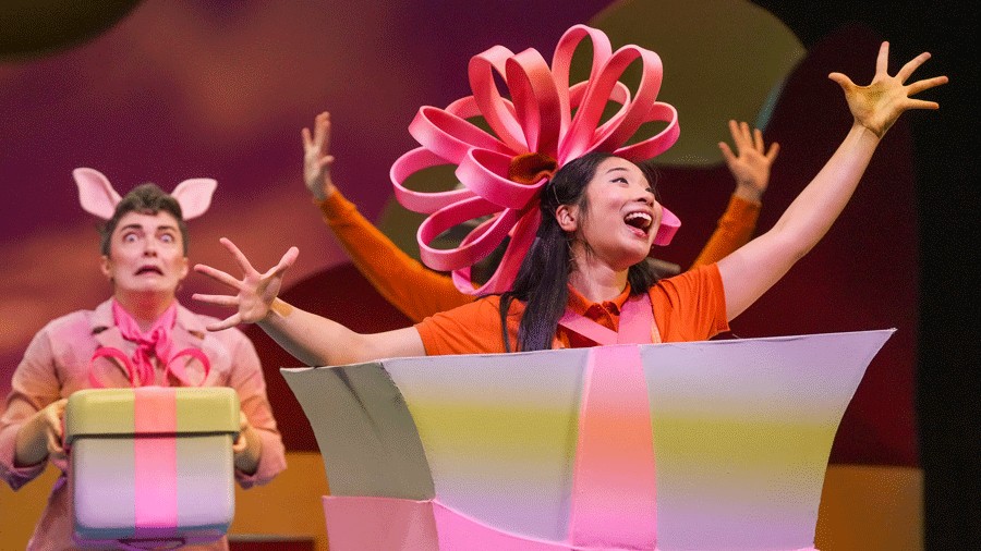 A present puppet sings on stage at SCT's 2025 holiday show