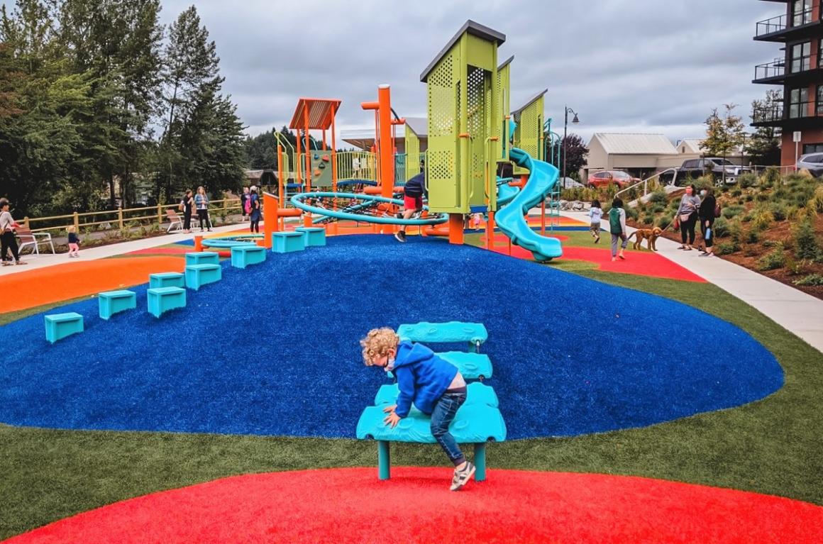 Young boy age 2 playing at brand new Totem Lake playground Kirkland Seattle family activities play stops