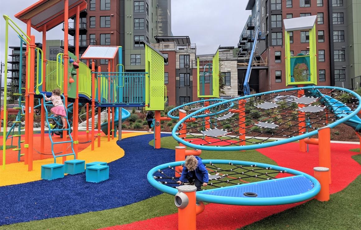 Cargo net ring climbers challenge kids at colorful new playground at Kirkland's Totem Lake Park near Seattle