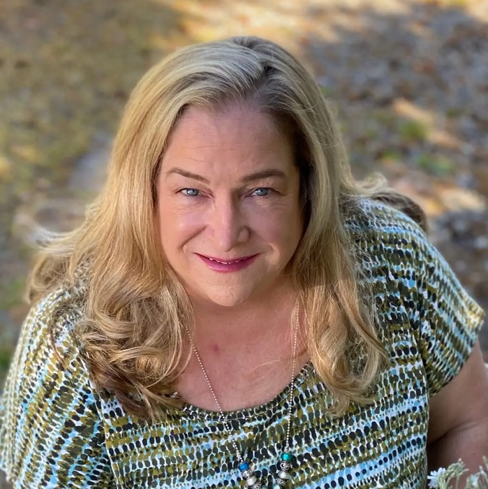 Headshot of ParentMap author Peggy Cleveland, a woman with long blond hair looking up at the camera