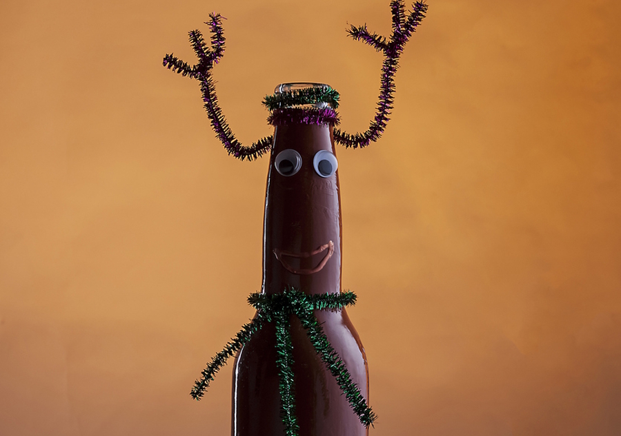 bottle with google eyes and pipe cleaners made to look like a reindeer