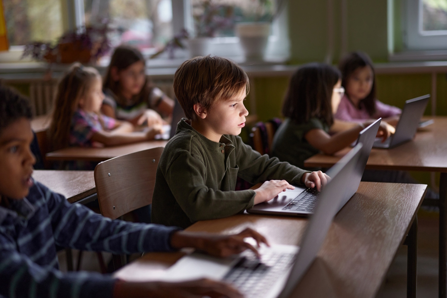 classroom full of students all using laptops