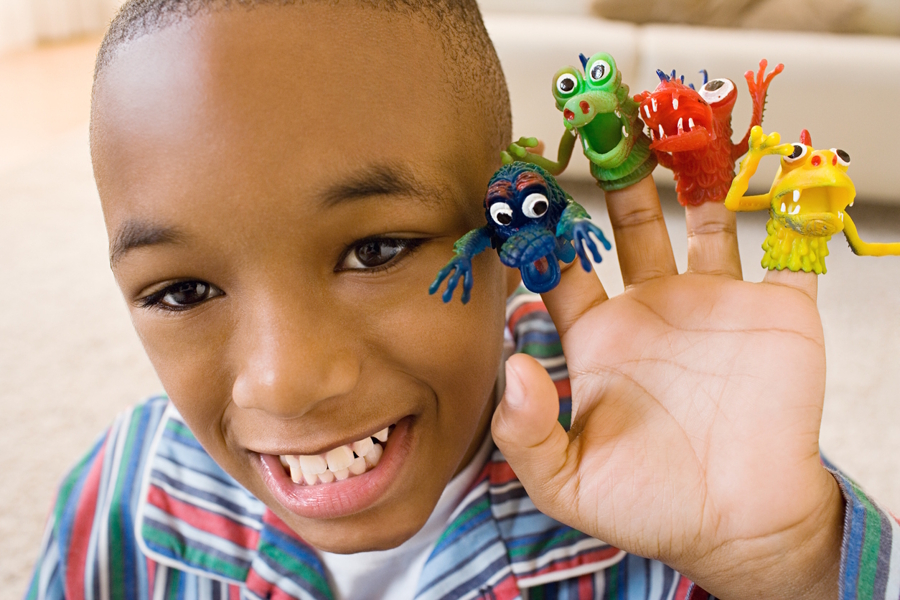 boy with small monster toys on fingers