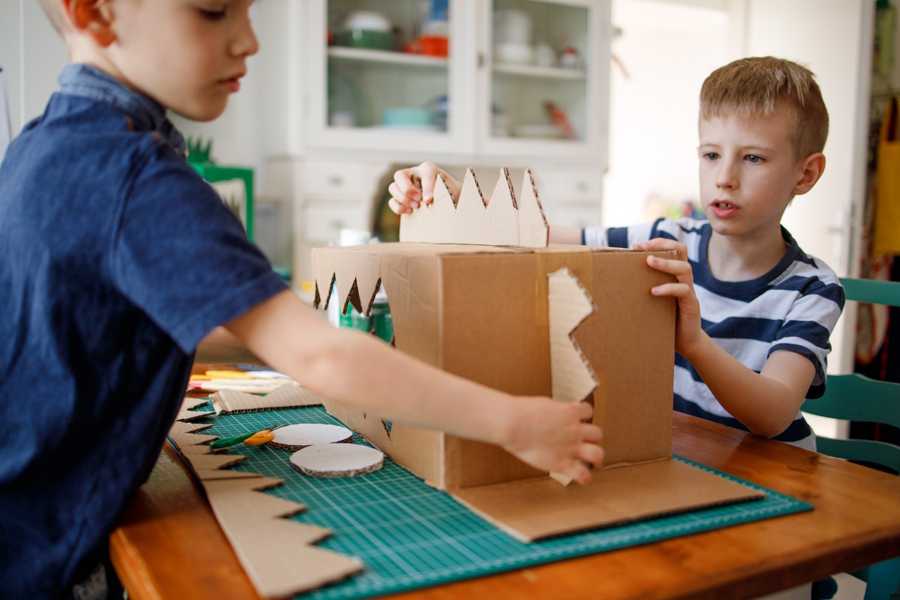 boys making something out of cardboard