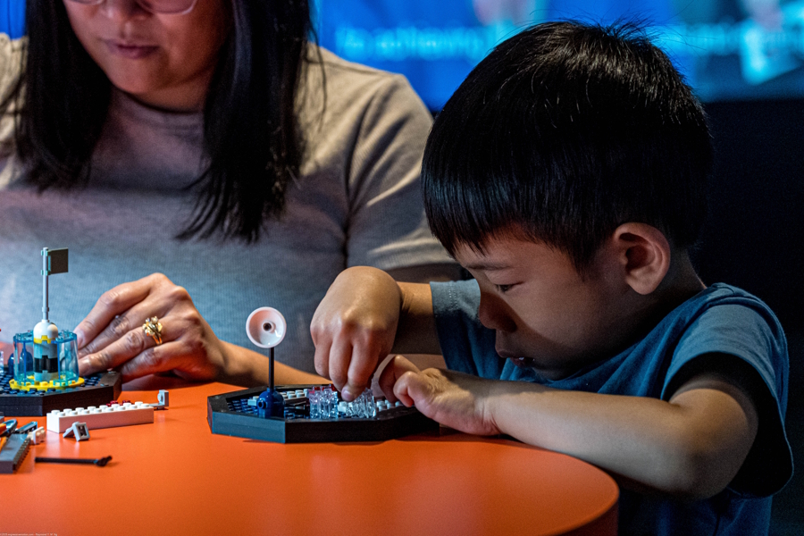 young boy building with Lego bricks