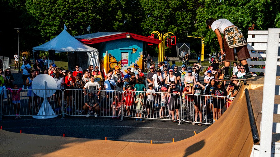 person skateboarding in a Bumbershoot Recess District while kids watch