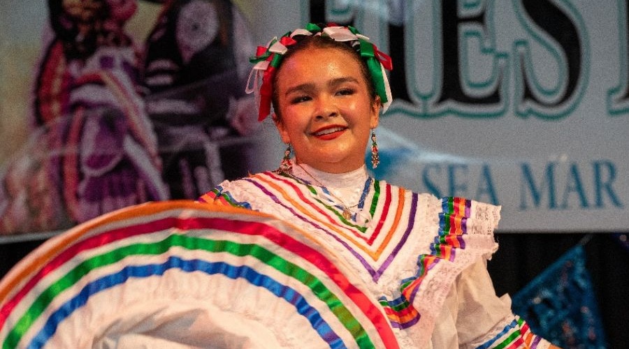 Dancer wearing colorful dress at Seattle Fiestas Patrias event.