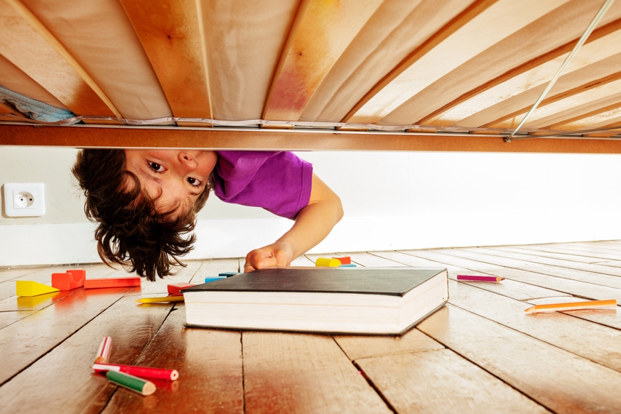 child looking under the bed