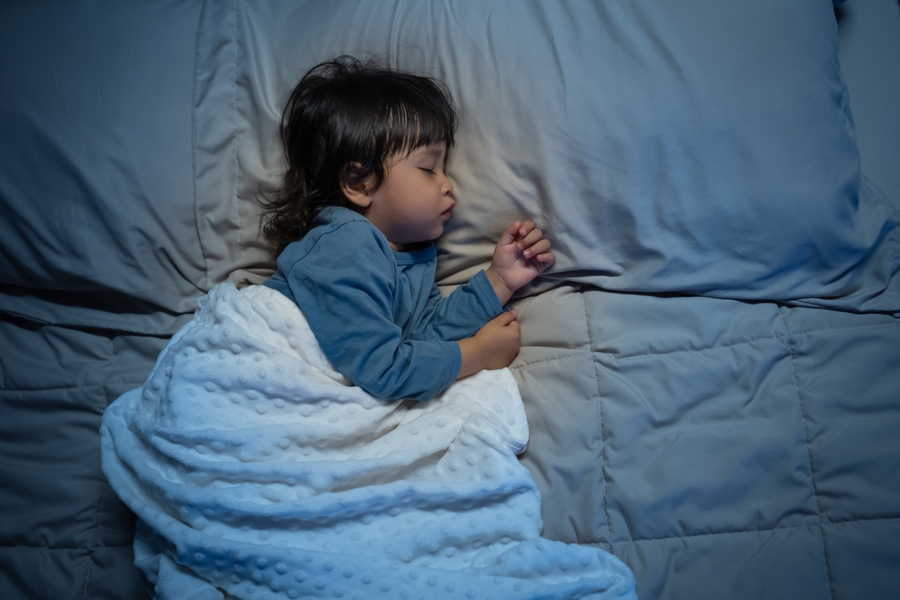 child sleeping in a dark room