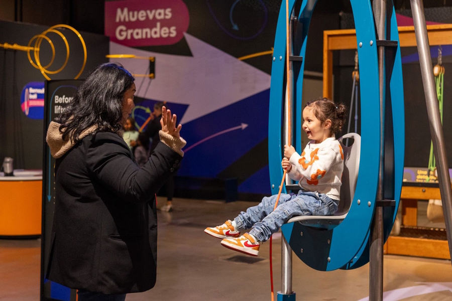 little girl playing with mom at Pacific Science Center