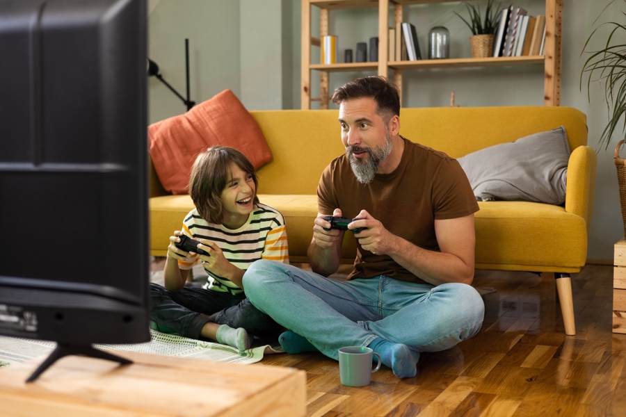 dad and child playing video games together