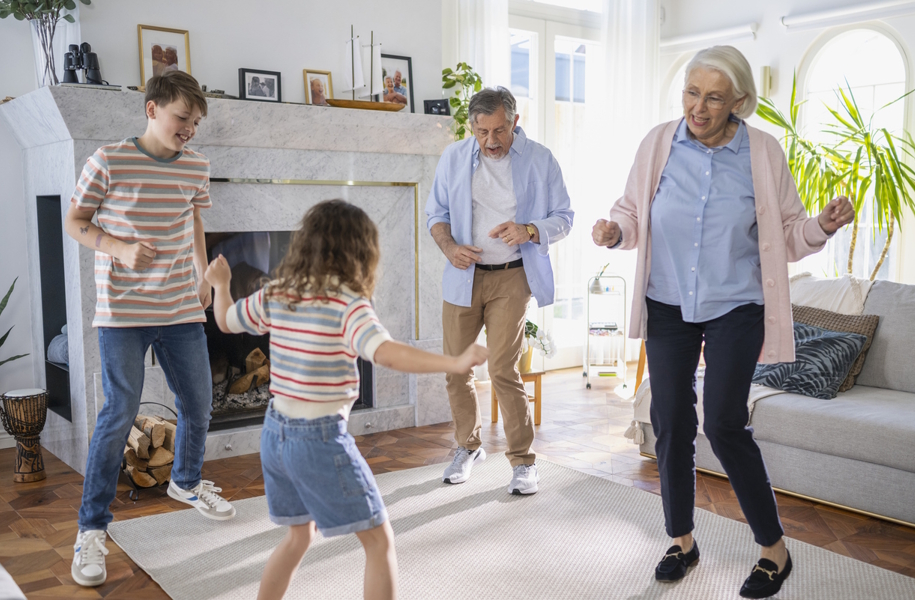 Family dancing together in the living room