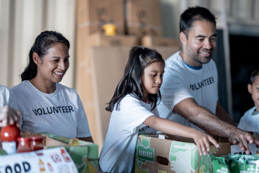 a family volunteering at a food bank