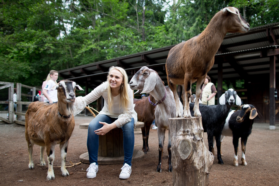 family with goats at the zoo