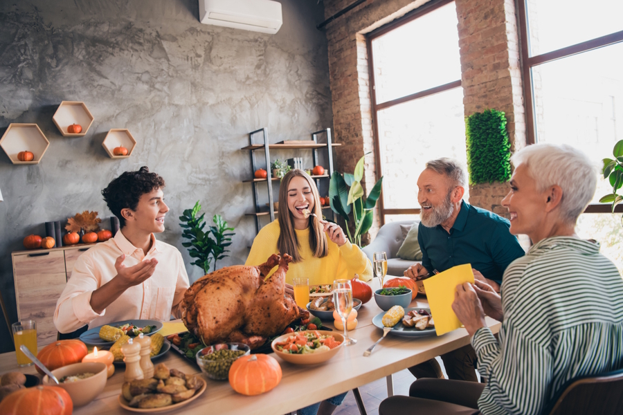 family with teenager children celebrating Thanksgiving together