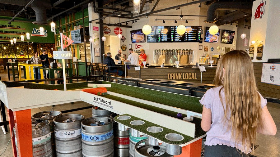 girl watching games at Flatstick Pub, a Seattle-area restaurant hosting Club World Cup 2025 watch parties