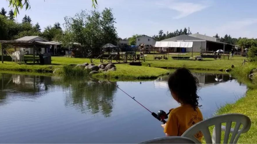 girl fishing quietly at a pond