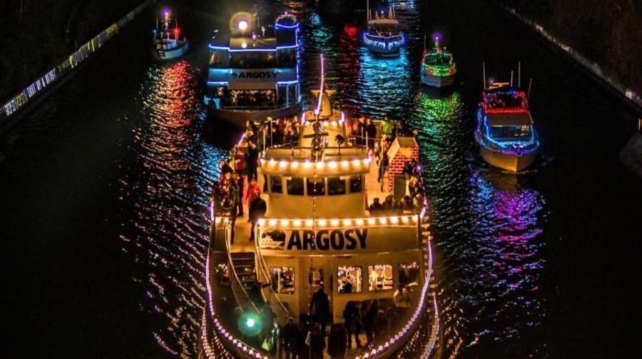 A lighted fleet of boats parades through the waters of Lake Union. 