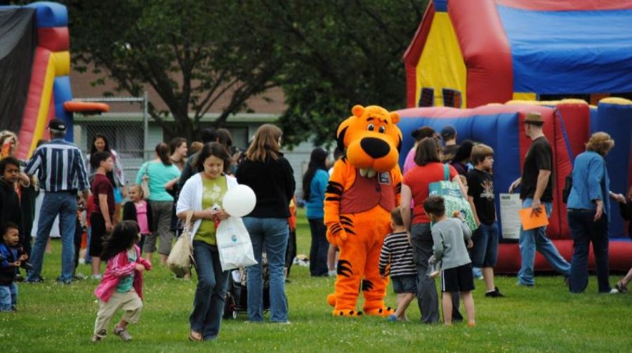 Kids enjoy bounce houses and play during Auburn's KidsDay.