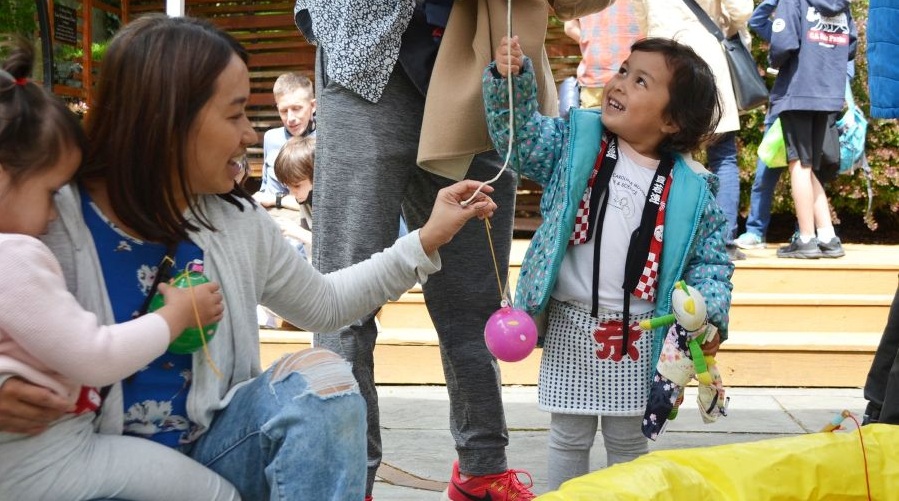 A young girls plays games at a Japanese cultural fair.