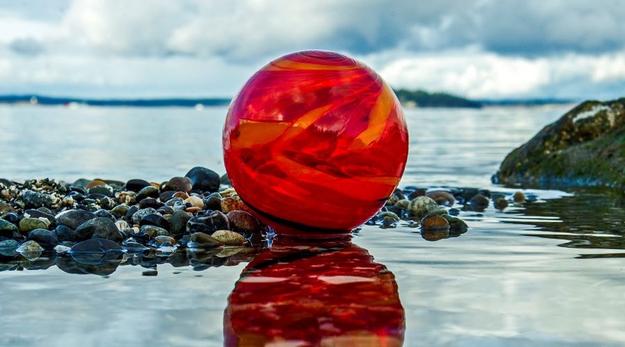 A red glass orb sits in the water during the Northwest Glass Quest.
