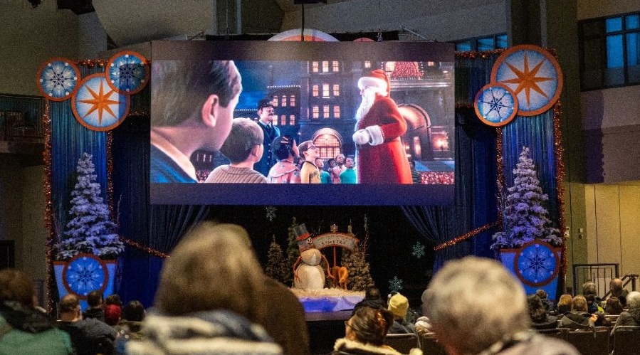 A crowd watches a free holiday movie at the Seattle Center.