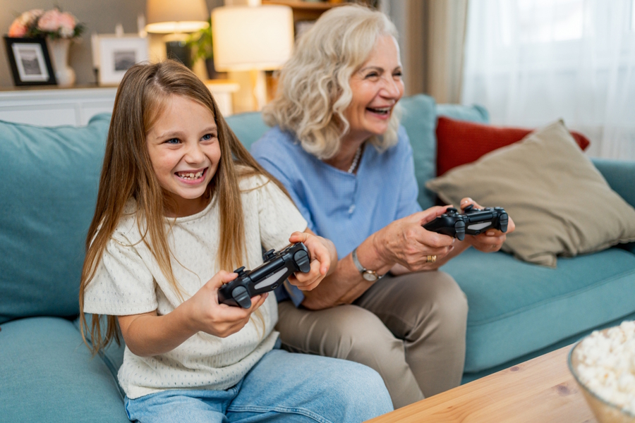 grandma and grandaughter playing video games together