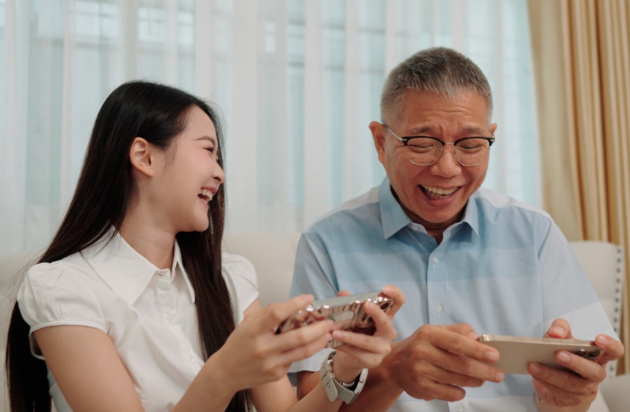 girl and grandpa enjoying time with a family game app