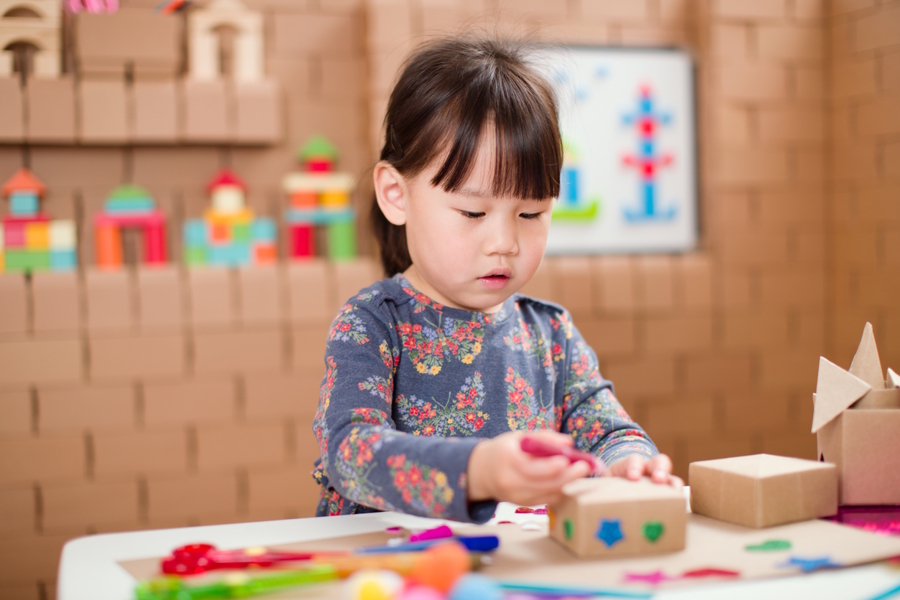 Girl decorating a keepsake box for her baby teeth
