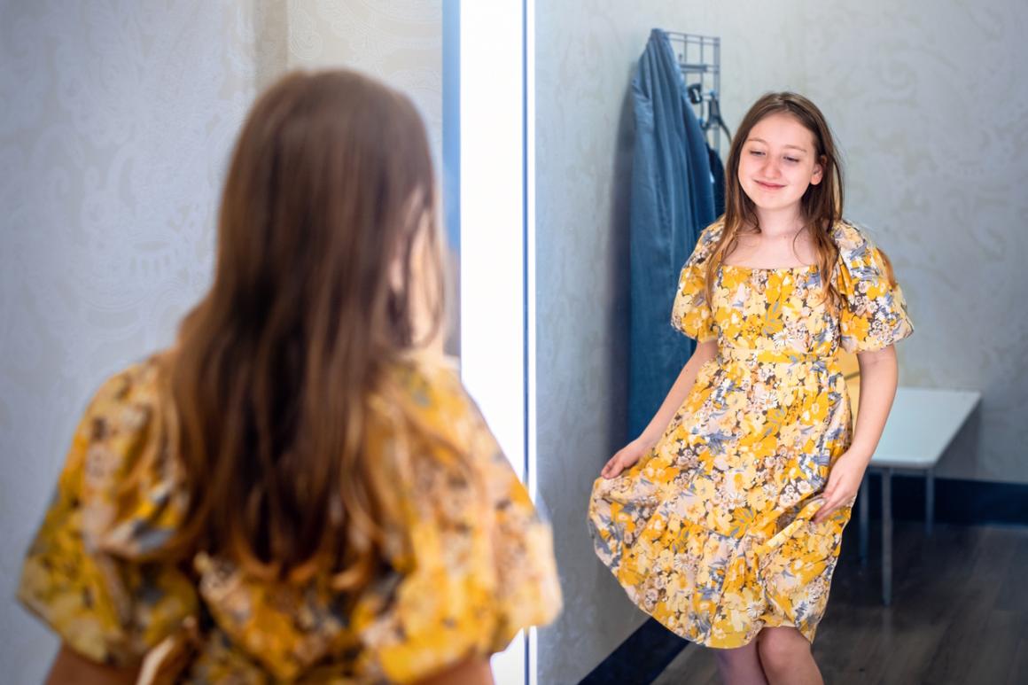 Girl looking in the mirror feeling self confident