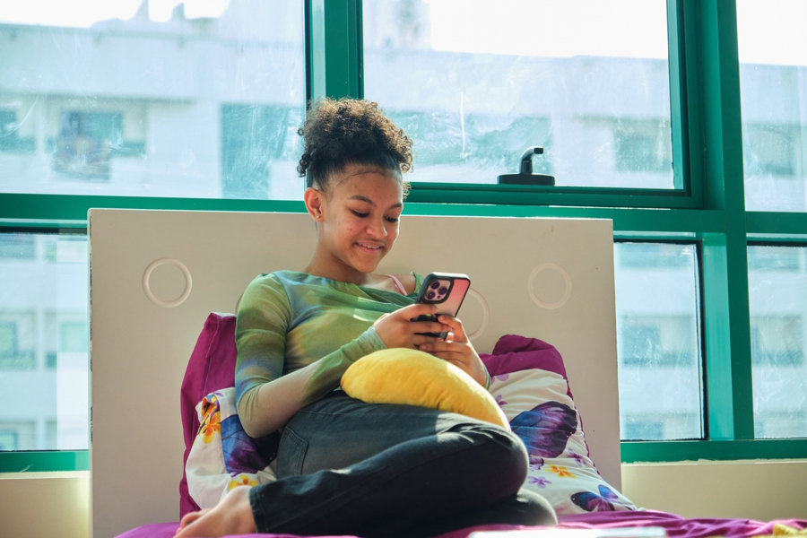 girl looking at social media on her phone 