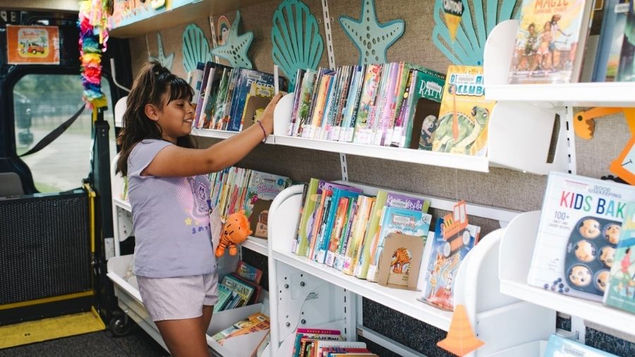 girl picking a book to read