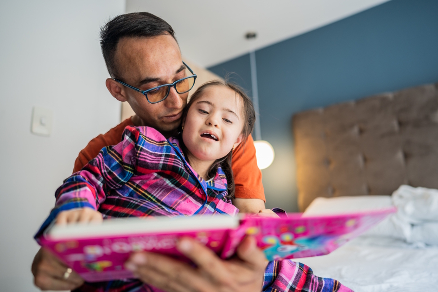 Girl reading a book with her dad