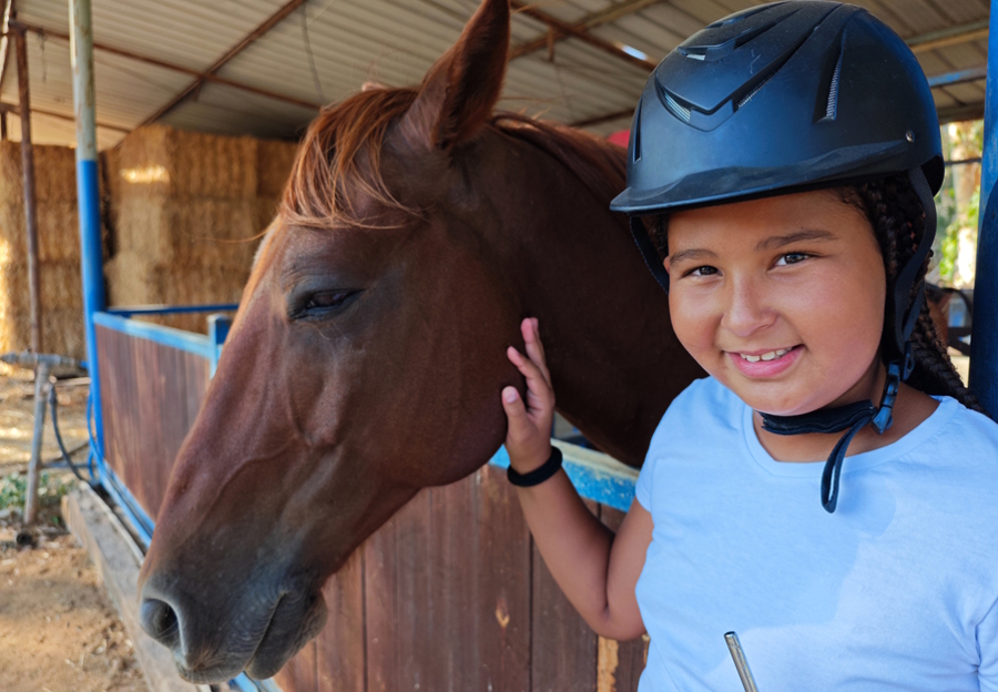 girl smiling with a horse
