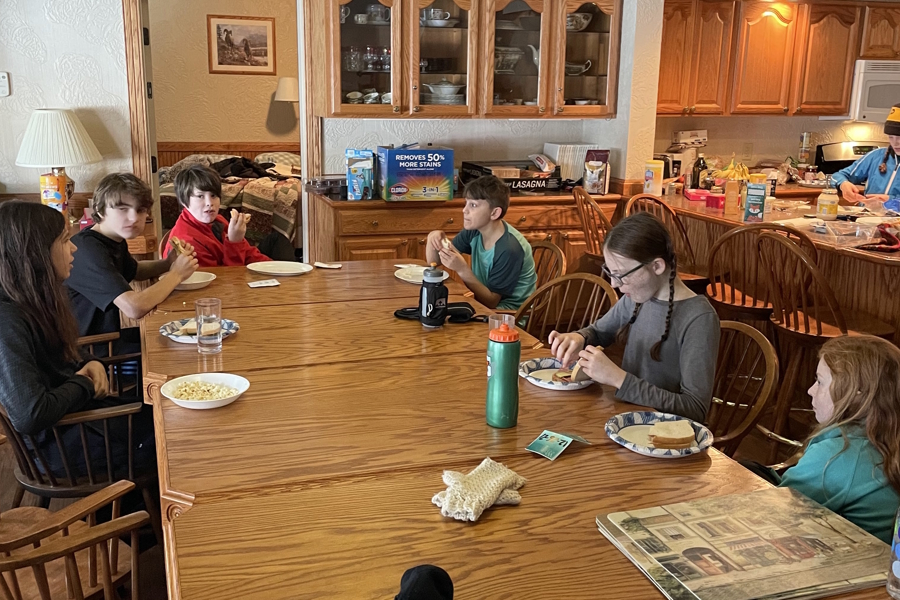 kids eating a casual lunch around a large kitchen table