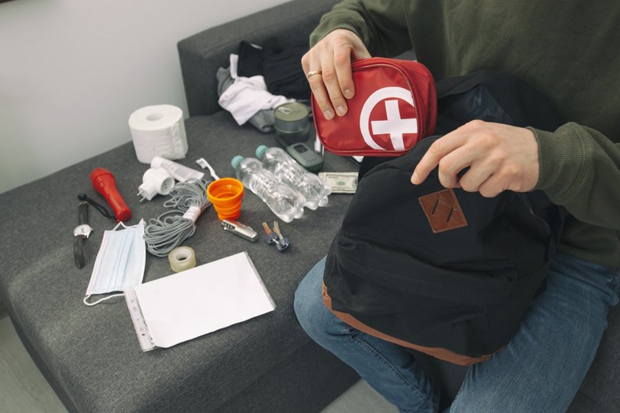 putting items in an emergency bag